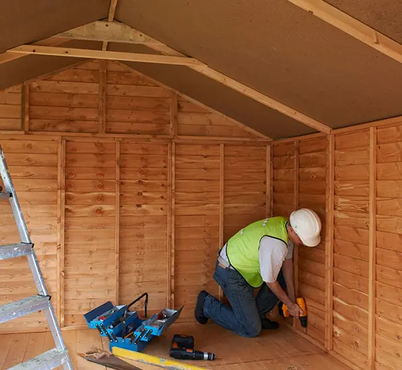 A man working in a shed with tools.