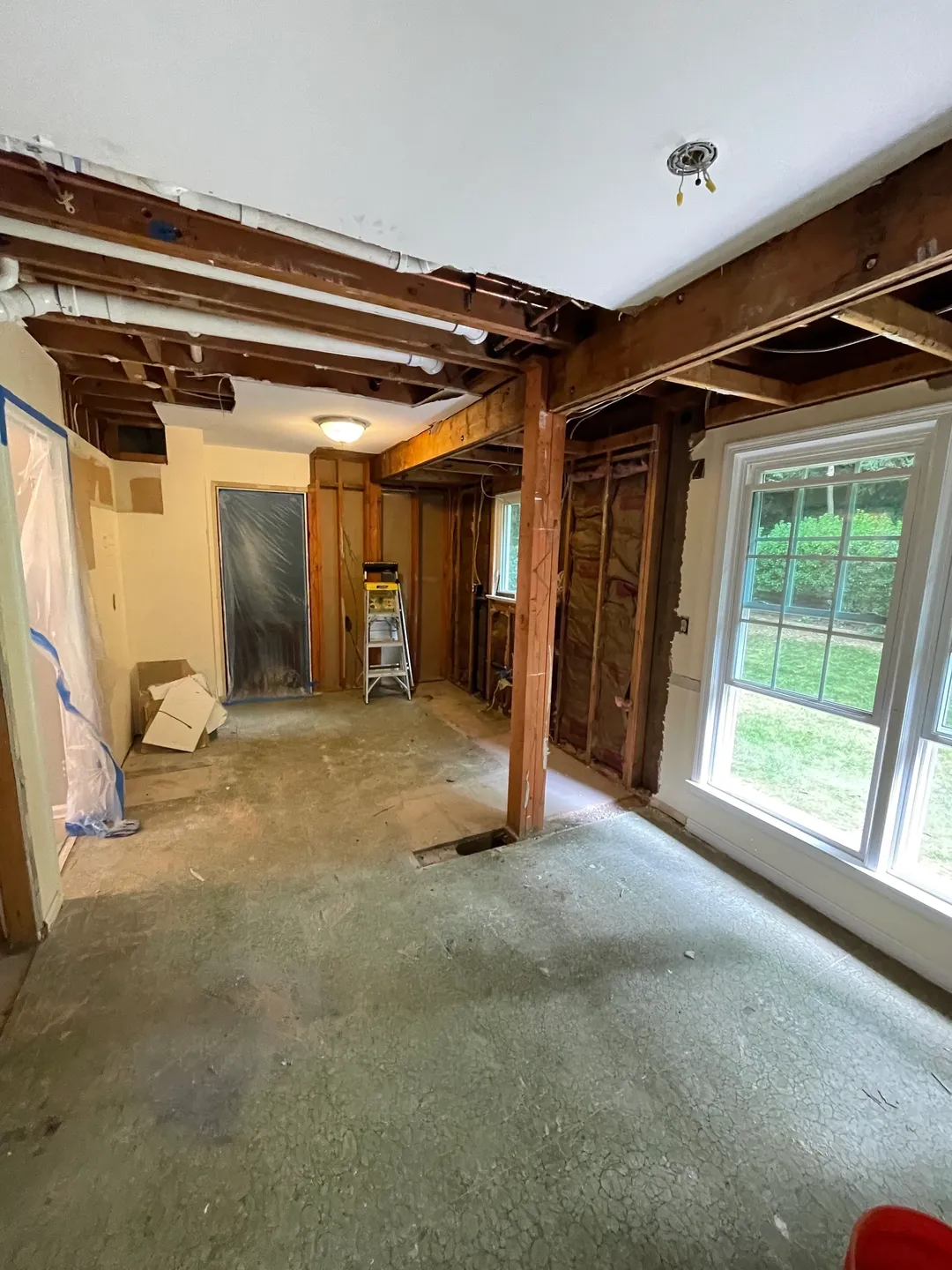 A room with exposed beams and windows in it.