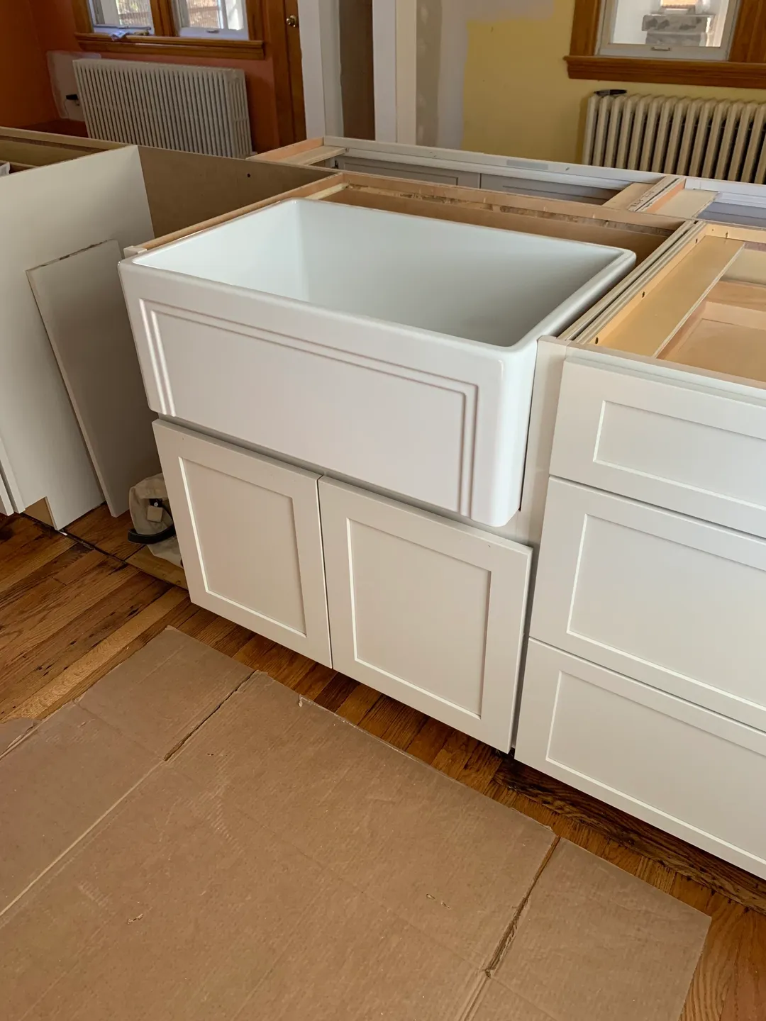 A white kitchen sink sitting in the middle of a room.