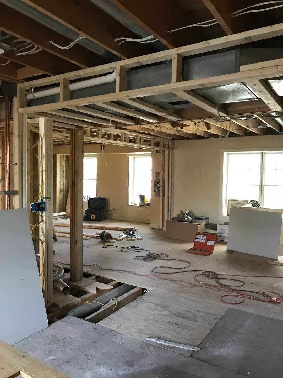 A room being remodeled with wood and metal beams.