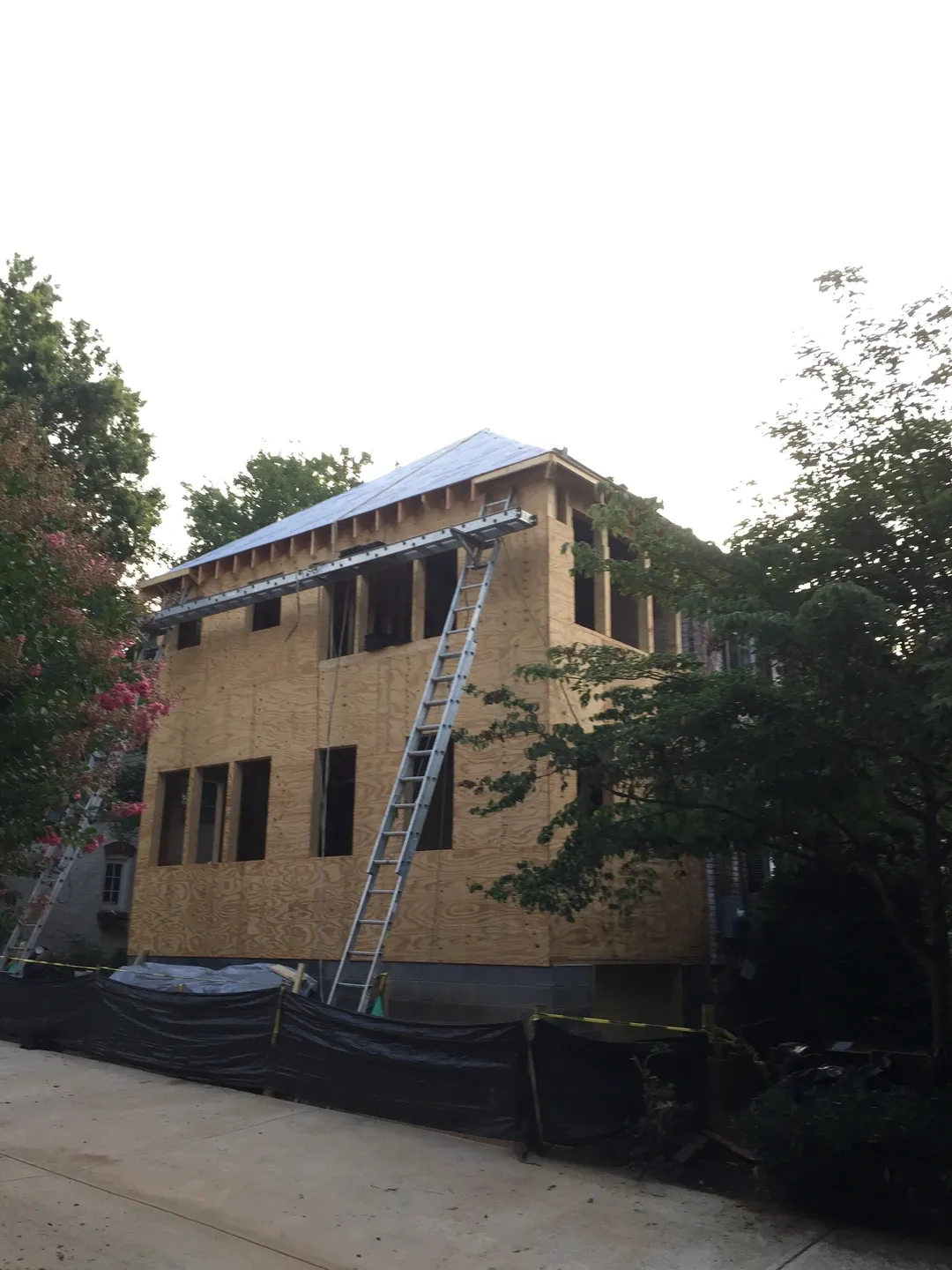 A building being built with ladders on the side.