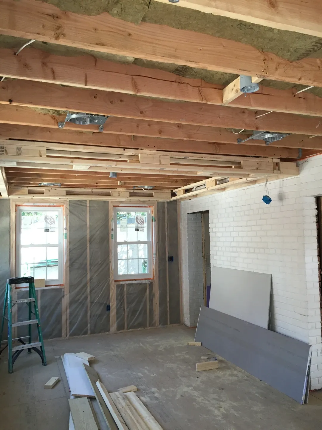 A room being remodeled with wood beams and walls.