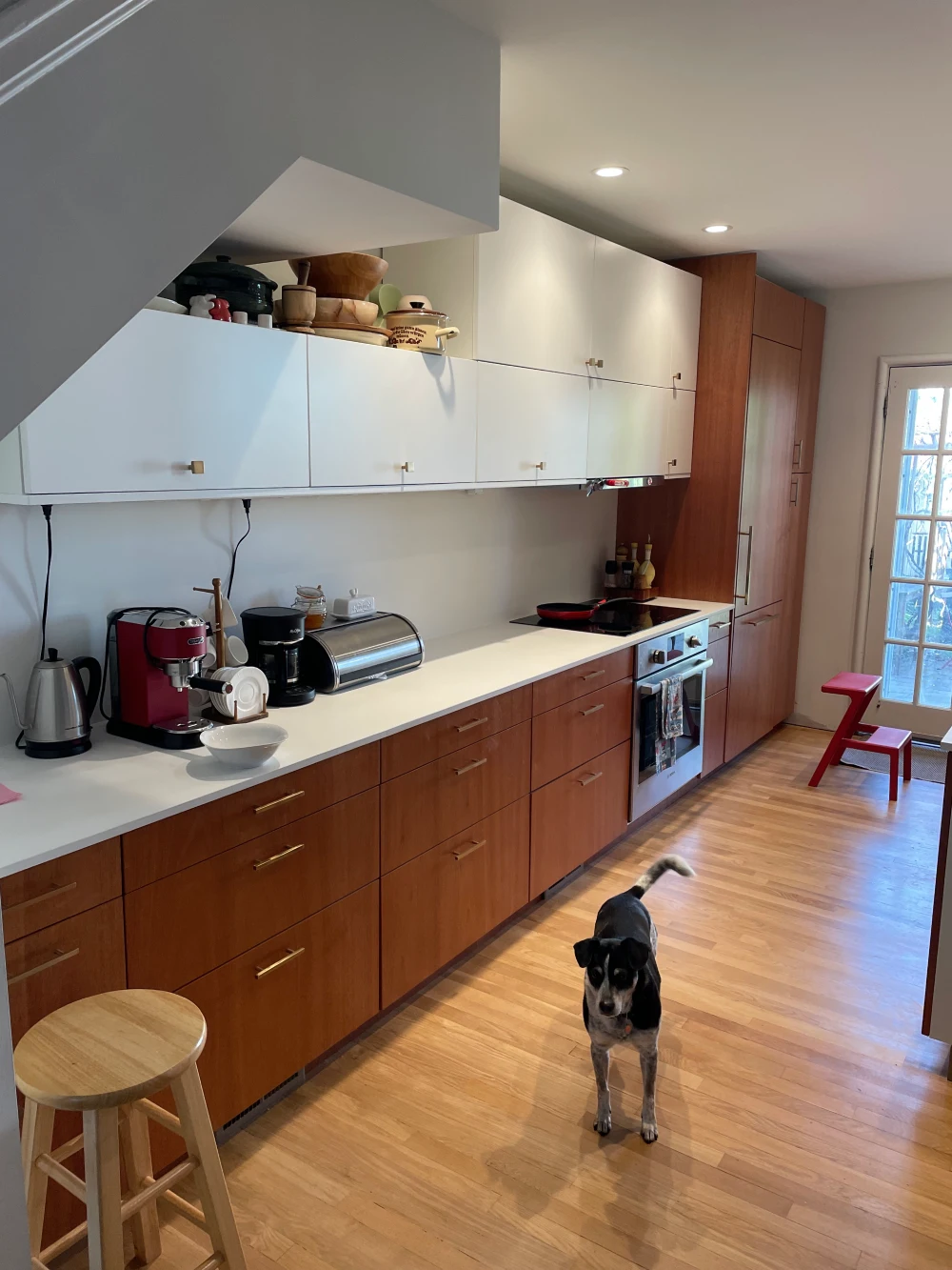 A kitchen with wooden cabinets and white counters.