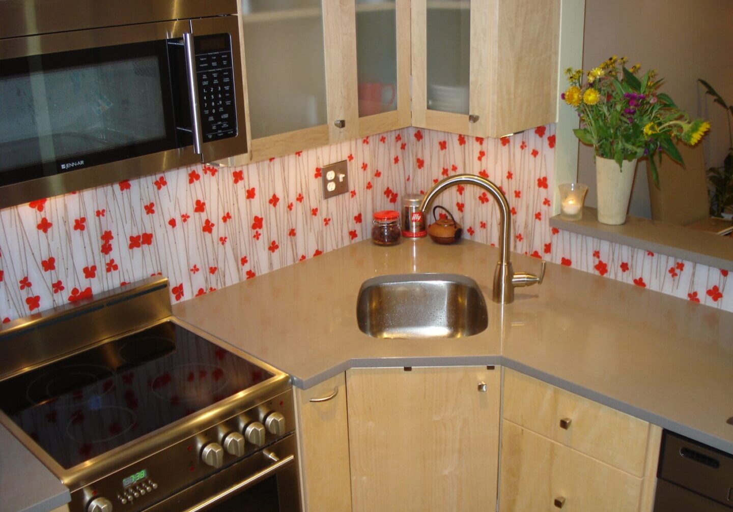 A kitchen with a sink and oven in it